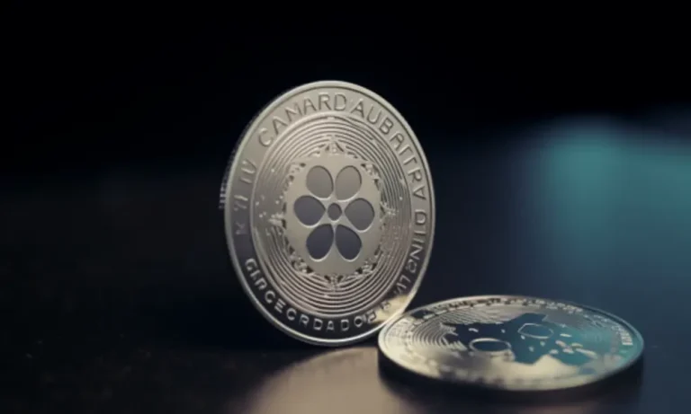 Ambcrypto A Coin With The Cardano Logo On On A Desk With A Pric C2830b84 8be2 4a97 Bf84 3bdd335b002a 1200x900 1000x600.webp.webp