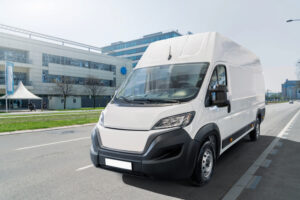 White delivery van on city street