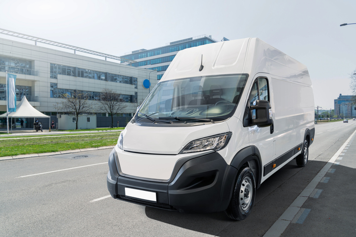 White delivery van on city street