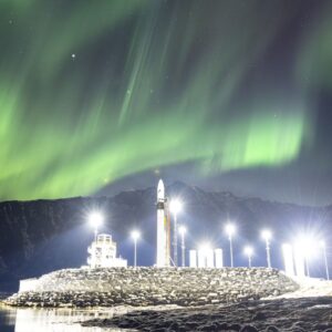 Foguete brilha sob a foto da aurora boreal do dia 25 de março de 2026