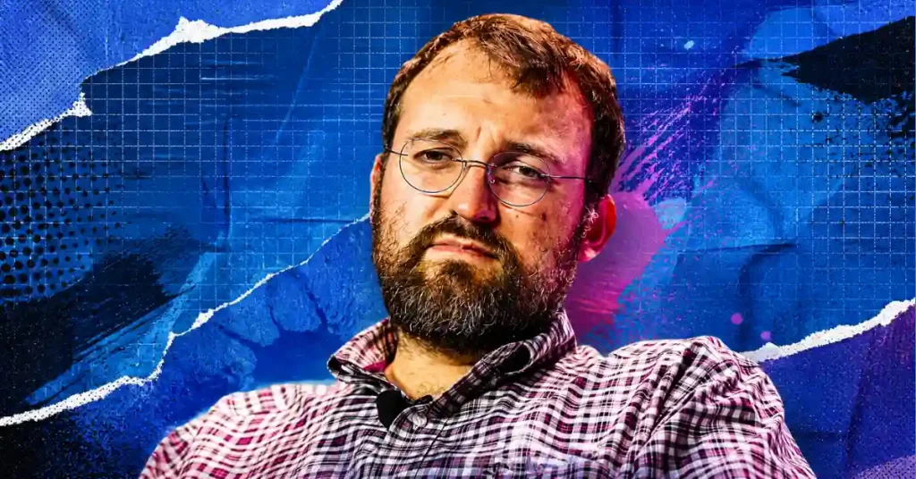 Um retrato do fundador da Cardano, Charles Hoskinson, em uma camisa xadrez e óculos contra um fundo abstrato azul e roxo vibrante com efeito de papel rasgado.